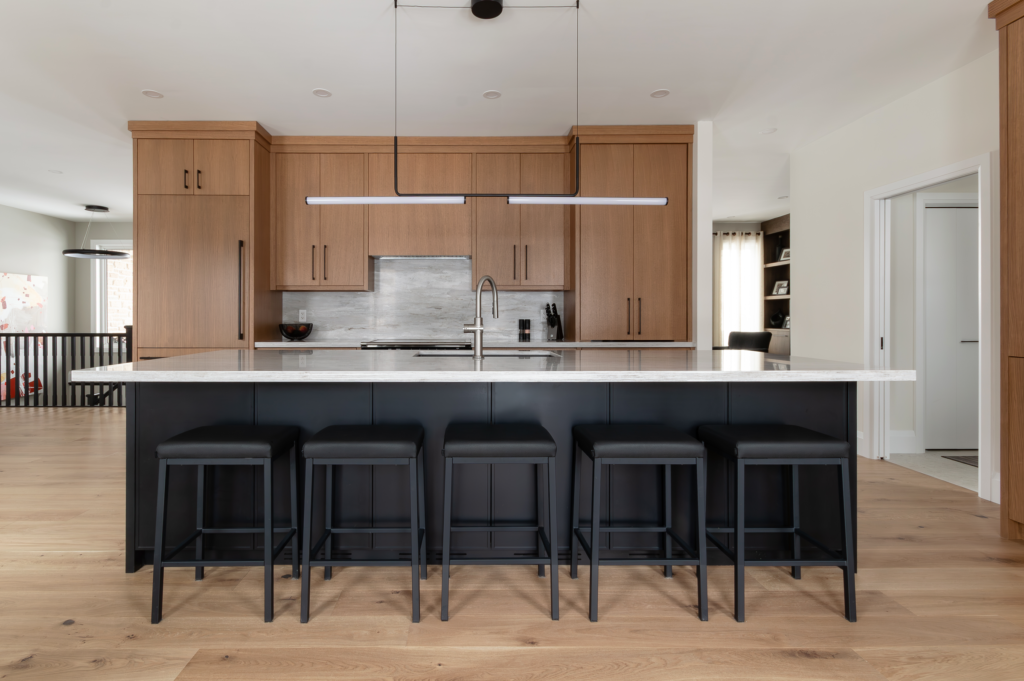 Beautiful white oak kitchen with contrasting black island cabinetry, and lovely quartz countertops. - Oakville Ontario Designed by: EKR Designs