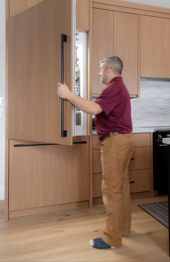 Modern rift-cut white oak kitchen with panel ready appliances- like this hidden fridge. - Oakville, Ontario Designed by EKR Designs
