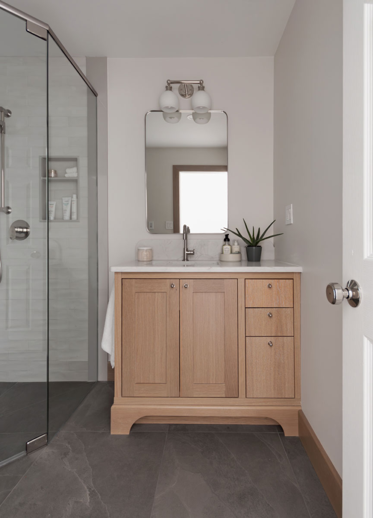 Custom white oak vanity with offset sink and decorative kick — Guelph, Ontario