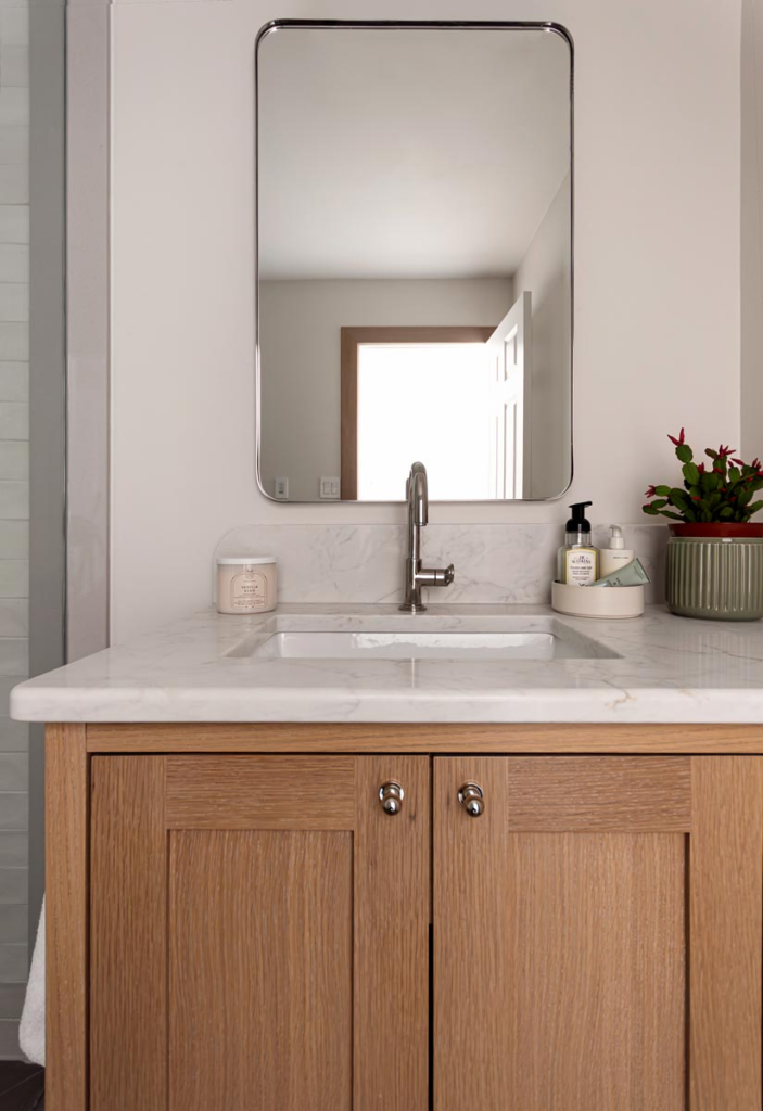 Custom white oak vanity with offset sink and decorative kick — Guelph, Ontario