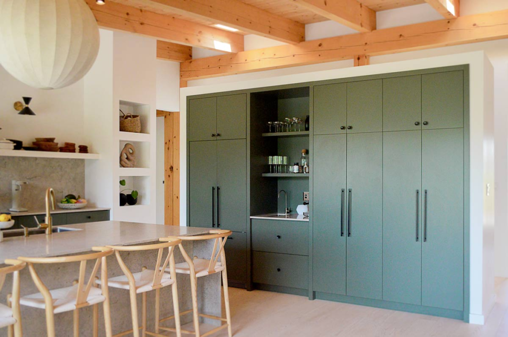 Beautiful custom dark green white oak kitchen with black hardware, and white range hood and shelf. - Puslinch Ontario
